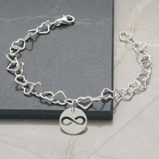 Sterling Silvert Heart link anktet With attached round Charm featuring a cut out infinity symbol