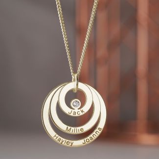 Three different sized gold ring discs layered on top of each other forming a pendant. Diamond set in the centre smallest ring. Engraved with names. 0n an optional gold curb chain